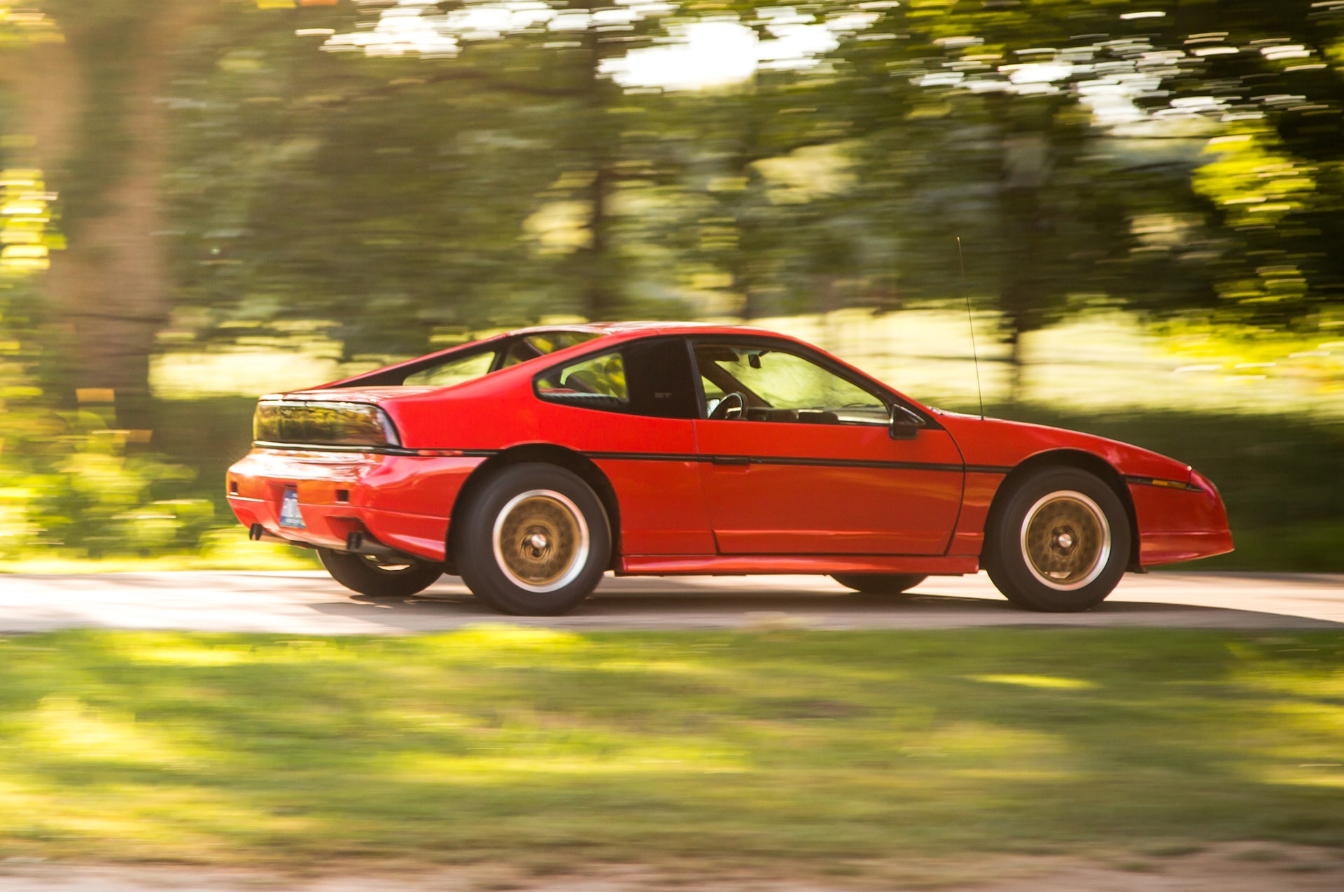 1988 Pontiac Fiero GT rear three quarter in motion 02